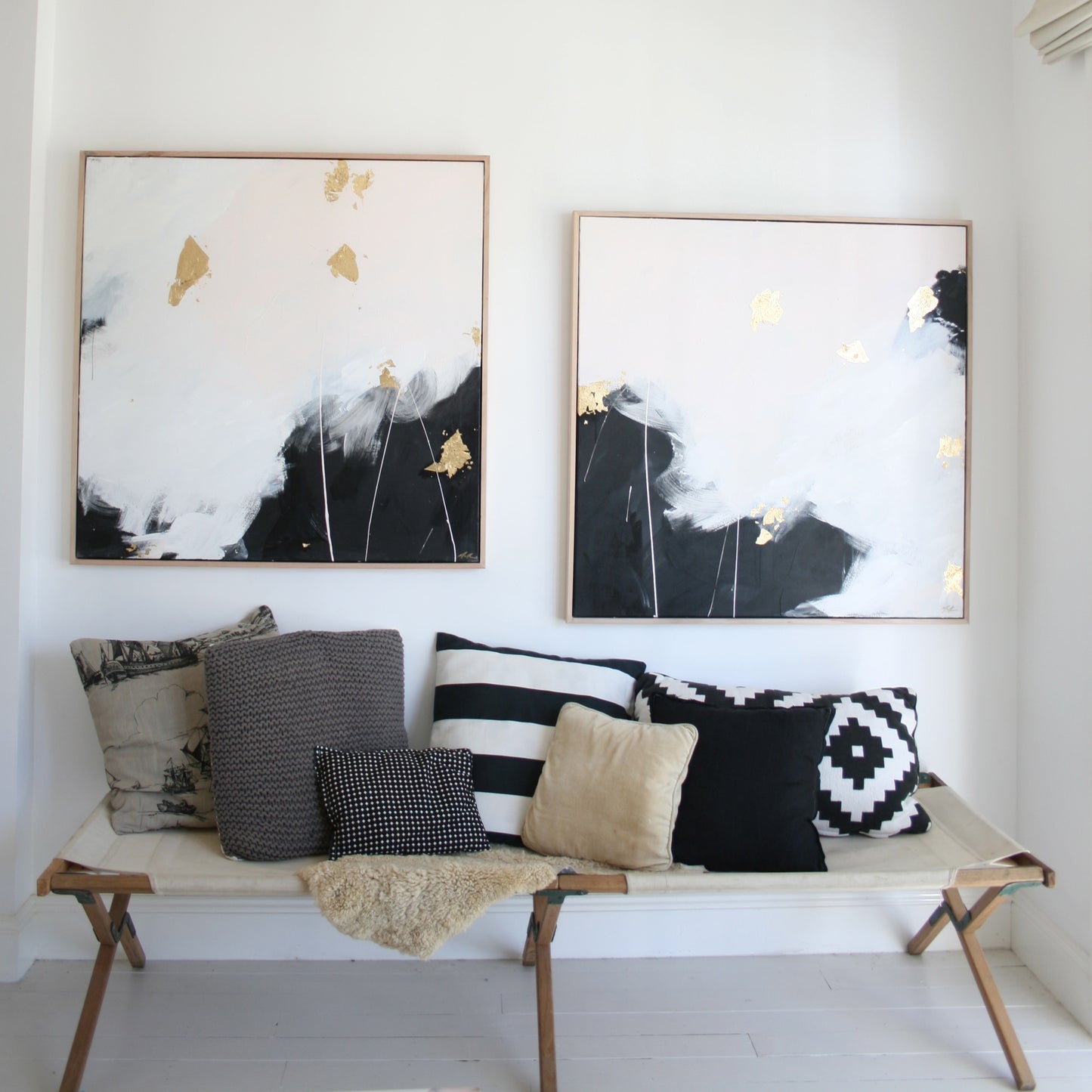Two paintings over camp bed