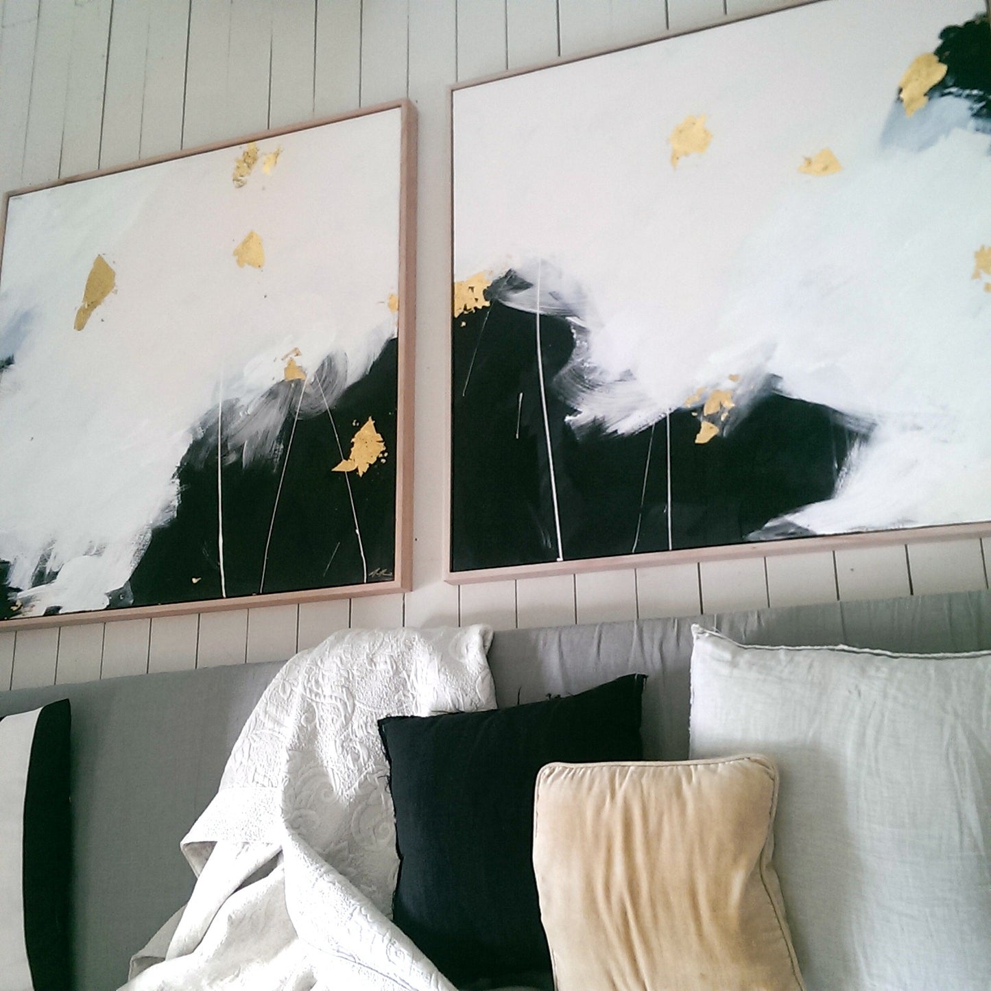 Monochrome paintings over the bed